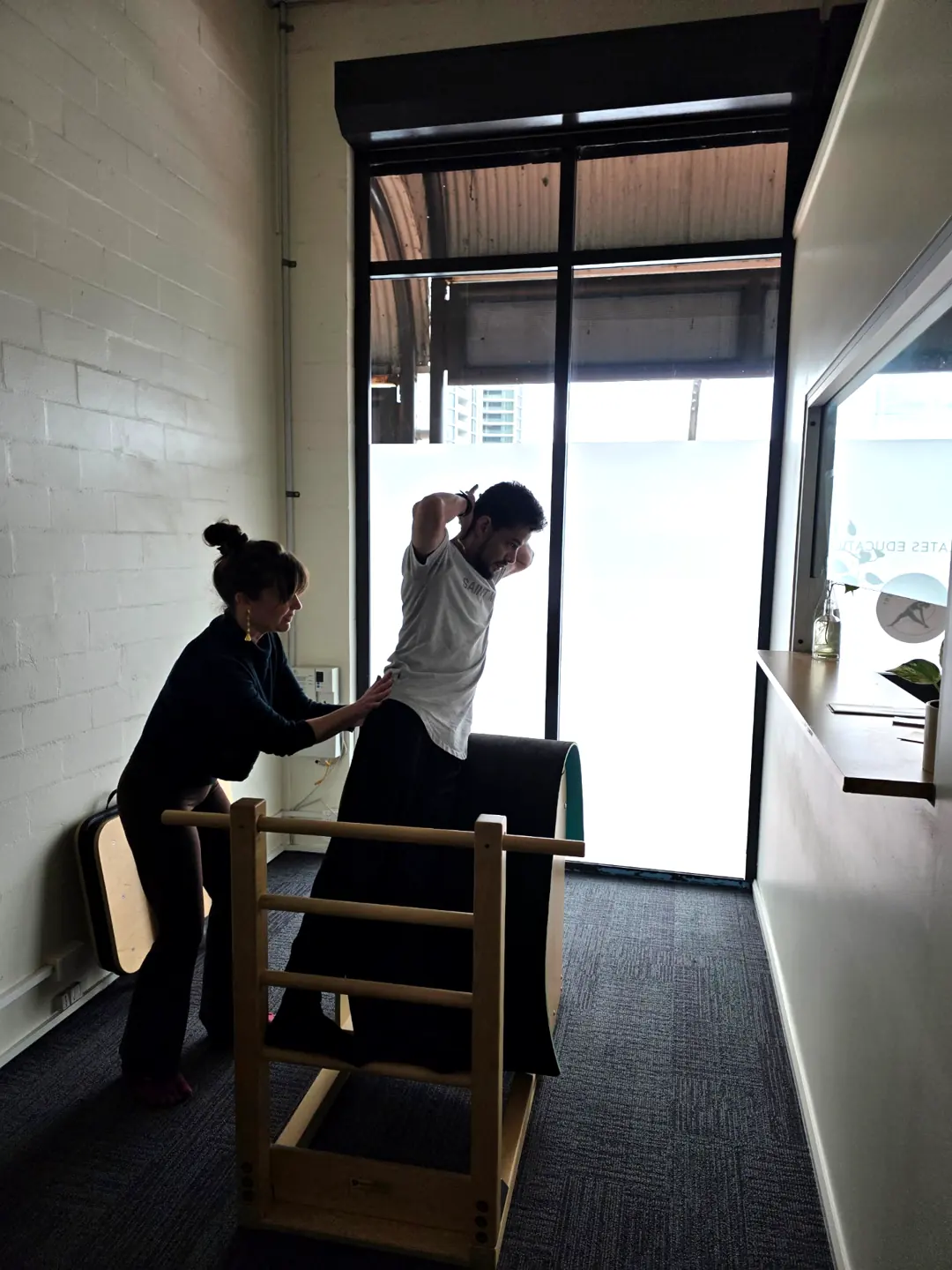 Pilates Wollongong hands on instructor assistance at the ladder barrel