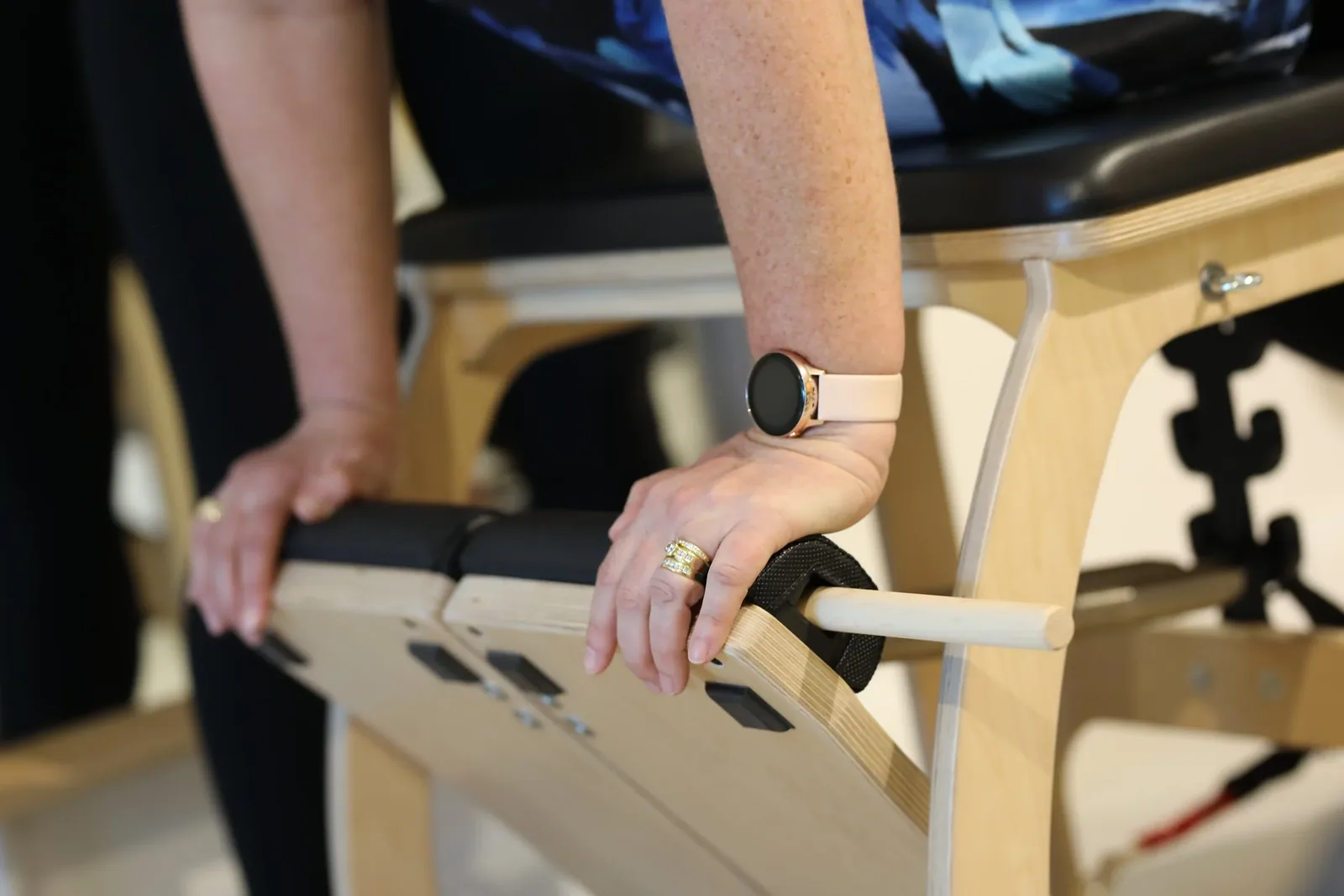 Close up of a client pressing the Wunda Chair pedal with both hands at Humans in Movement Wollongong
